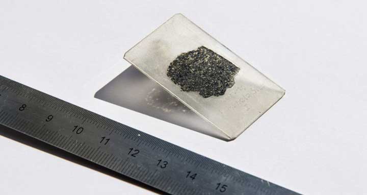 Photo provided by Hillary Sanctuary of EPFL shows a thin slice of the meteorite sample from a meteorite that fell to Earth more than a decade ago providing compelling evidence of a lost planet that once roamed our solar system, according to a study published Tuesday. (Hillary Sanctuary/EPFL via AP)