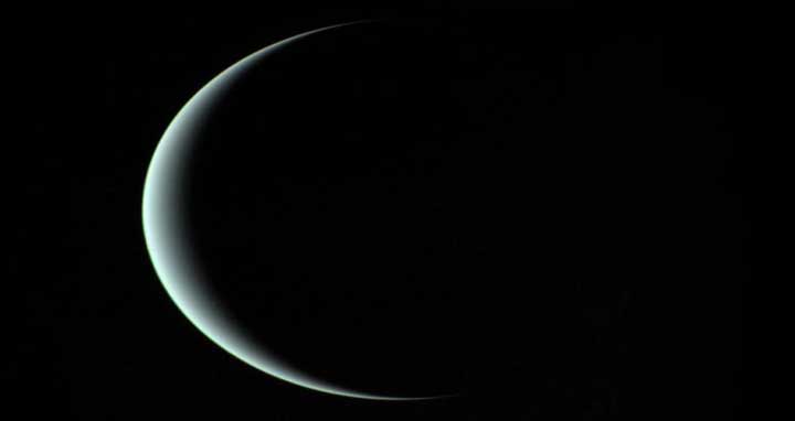 This image of a crescent Uranus, taken by Voyager 2 on January 24th, 1986, reveals its icy blue atmosphere. Despite Voyager 2’s close flyby, the composition of the atmosphere remained a mystery until now. Image credit: NASA/JPL