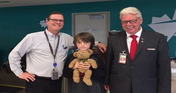 It was a happy reunion at the cargo area of the Charlottetown airport for nine-year-old Henry and his teddy bear Sutton. Assisting with the happy occasion are Air Canada employees Mark MacDonald, left, and Merrill Bell. (Submitted photo) - Bill McGuire